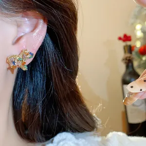 Exquisite close-up of gold-plated horse stud earring with sparkling colorful zircon stones