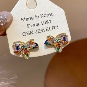 Close-up of horse-shaped earrings with colorful baguette-cut cubic zirconia stones