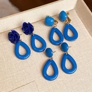 Boucles d'oreilles rétro bleues en acrylique avec fleurs et gouttes sur un plateau
