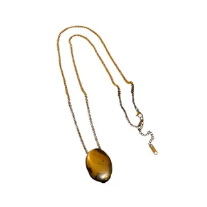 Elegant gold titanium steel necklace featuring a smooth polished oval pendant design