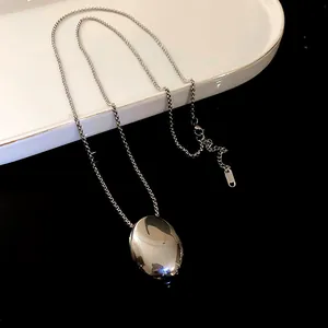 Minimalist polished silver oval pendant necklace on a sleek titanium steel chain