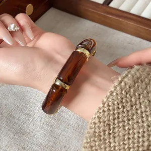 Close-up of a vintage tortoiseshell resin cylindrical beaded stretch bracelet on wrist