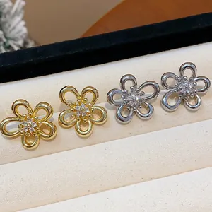 Macro view of elegant silver needle flower stud earrings with sparkling zircon centers