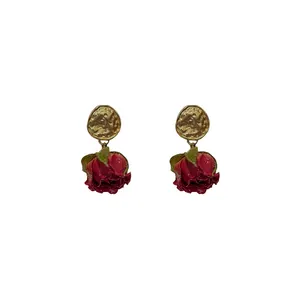 Elegant vintage silver needle drop earrings with realistic red preserved rose buds