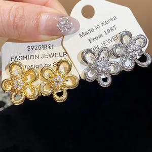 Close-up view of elegant zircon-encrusted flower stud earrings with S925 silver needles