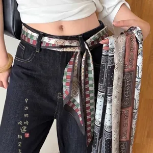 Vintage ethnic fabric belt with paisley pattern used as a silk scarf waist chain.