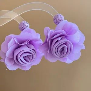 Macro view of elegant purple chiffon flower earrings showcasing delicate petal texture