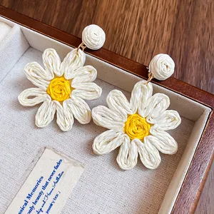 Handmade woven fabric daisy flower earrings in white and yellow, perfect for summer vacation