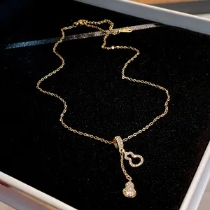 Detailed macro view of a golden hulu gourd pendant necklace with pavé zircon stones
