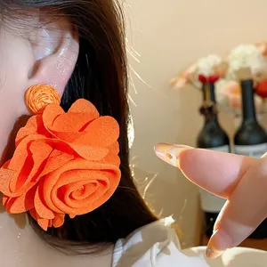 Large orange chiffon flower earrings with raffia woven base for a vintage bohemian style