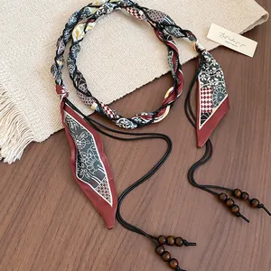 Macro view of a retro ethnic style fabric waist chain with wooden beads and tassels
