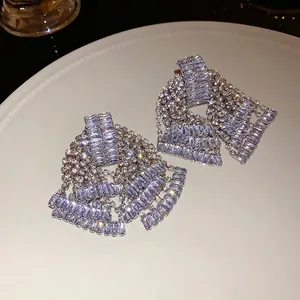 Elegant silver-toned bow drop earrings featuring shimmering rhinestone tassels for women