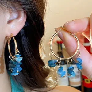 Elegant gold hoop earrings with blue irregular stone tassels and silver needles