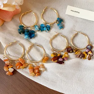 Close-up of handmade irregular natural stone tassel hoop earrings in various colors