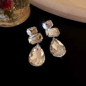 Primo piano di eleganti orecchini pendenti con strass a goccia e perni in argento