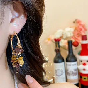Close-up of irregular stone tassel hoop earring worn on model for ethnic style