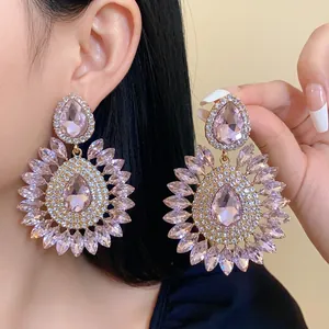 Exaggerated pink rhinestone flower earrings with teardrop design and silver needles