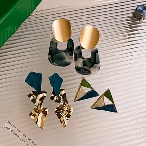 Detailed view of geometric resin and metal drop earrings in multiple vintage styles