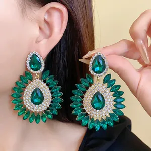 Close-up view of elegant green water drop flower drop earrings with sparkling crystals