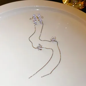 Close-up of elegant silver tassel ear threads with sparkling crystal flower clusters