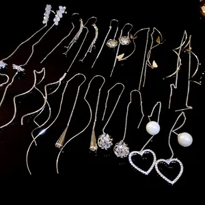 Elegant collection of long threader earrings with rhinestones, pearls, and heart charms.