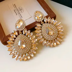 Close-up of elegant champagne teardrop flower earrings with rhinestone embellishment