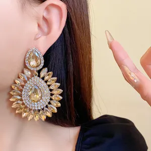 Close-up detail of champagne crystal flower earrings with sparkling rhinestone pave