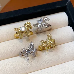 Elegant gold and silver horse-shaped open rings with heart zircon in a jewelry box