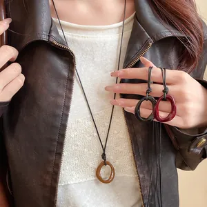 Close-up of retro irregular geometric oval resin pendant necklaces in multiple colors