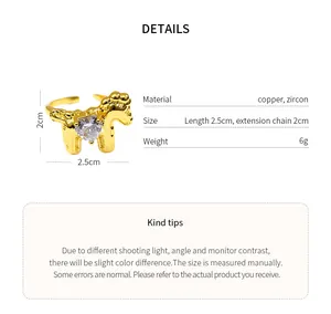 Detailed view of the gold-tone horse-shaped ring featuring a sparkling heart zircon stone