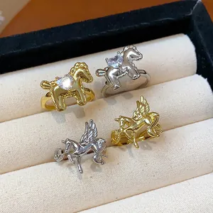 Close-up of elegant gold and silver horse rings featuring sparkling heart zircon stones