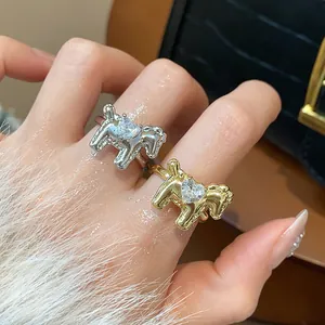 Detailed view of exquisite gold and silver horse-shaped open rings with heart zircon inlay