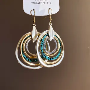 Macro detail of retro bohemian multi-layered irregular circular hoop dangle earrings