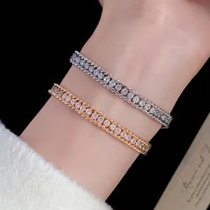 Close-up of elegant gold and silver twisted chain bracelets with sparkling rhinestones