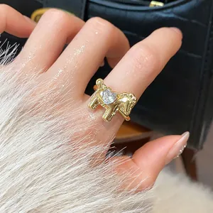 Detailed view of a gold-plated horse-shaped open ring featuring a clear heart-shaped zircon.