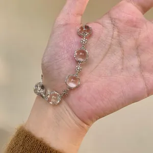 Close-up of elegant snowflake beaded bracelet with translucent stones on hand