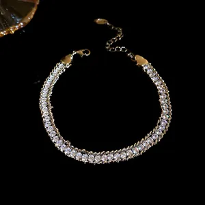 Close-up of elegant double-row sparkling crystal bracelet with gold chain detail.