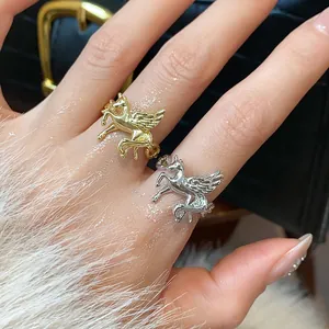 Detailed view of gold and silver Pegasus open rings with shimmering zircon accents.