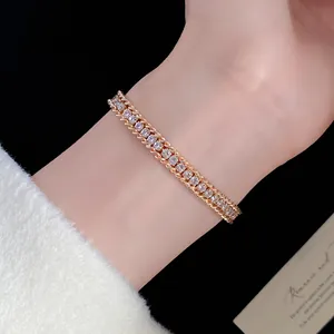 Detailed view of a dainty gold wrapped chain bracelet set with sparkling diamonds.