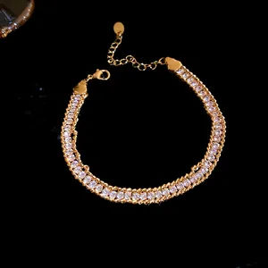 Detailed view of gold twisted chain bracelet with sparkling inset rhinestones