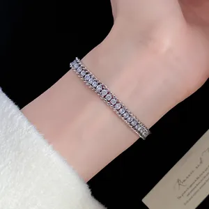 Detail view of a silver-toned twisted chain bracelet with shimmering diamond-set stones.