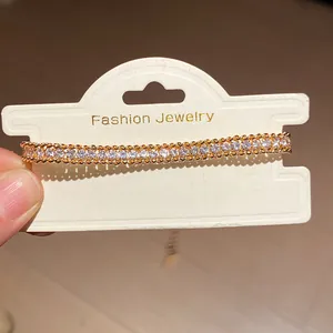 Close-up of elegant gold chain bracelet with shimmering inlaid clear rhinestones