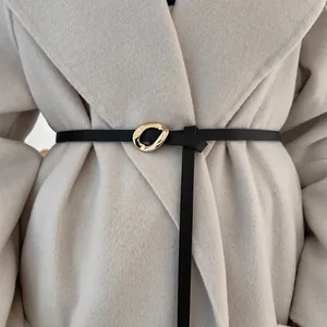Thin black leather belt for women's coat featuring irregular gold-tone buckle