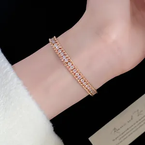 Close-up of elegant gold twisted chain bracelet with shimmering diamond-set stones