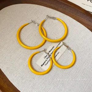 Minimalist yellow drip oil hoop earrings with silver needles in two sizes for women