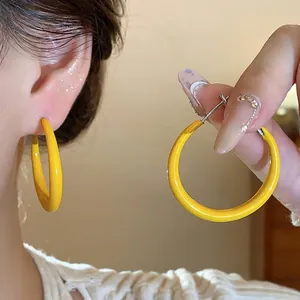 Minimalist yellow enamel hoop earrings with silver needles for a stylish and elegant look