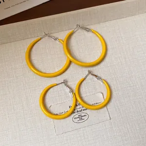 Minimalist yellow enamel hoop earrings with silver needles in two sizes for women