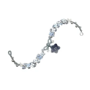 Handcrafted resin floral bracelet with bow and star charm, elegant blue aesthetic.