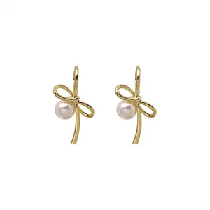 Elegant gold-tone bow knot hoop earrings with white pearl detail for women
