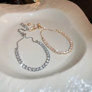 Detailed view of sparkling cubic zirconia adjustable tennis bracelets in gold and silver.